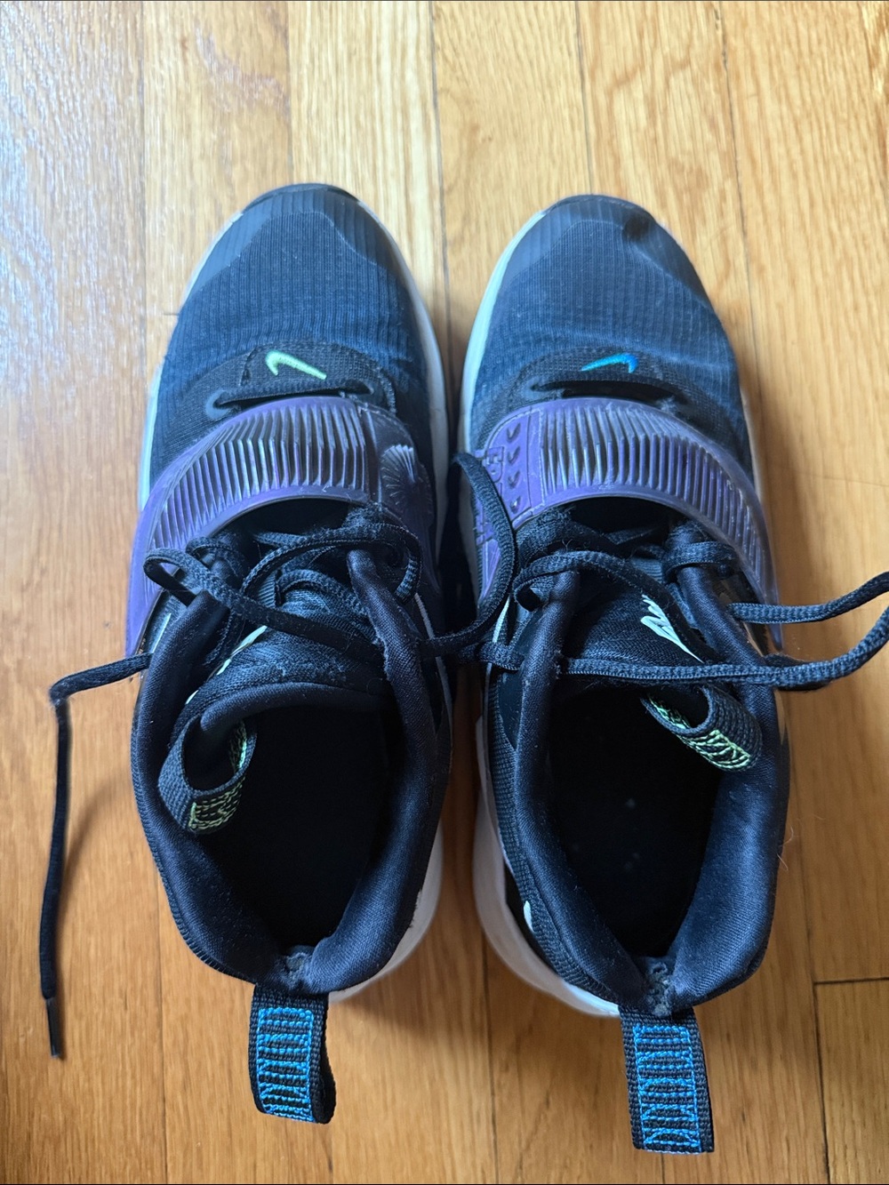 Nike Kids Black Sneakers with Purple Accents and Teal Logo